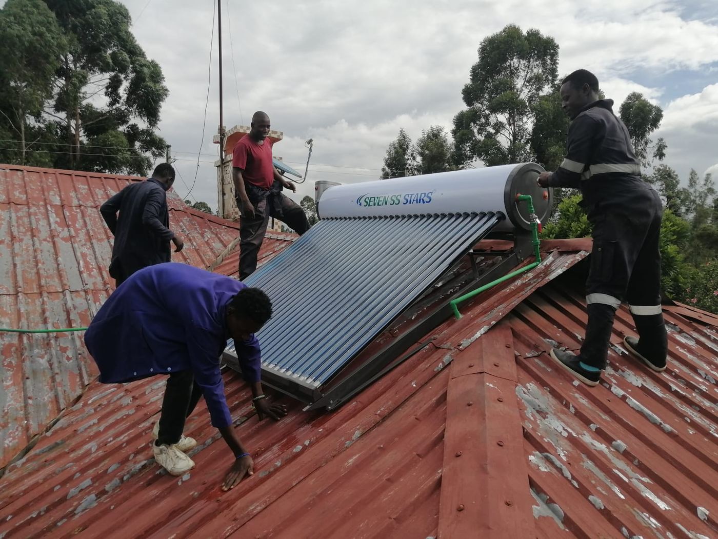 The Vegaz team installing a solar water heater on a client's roof