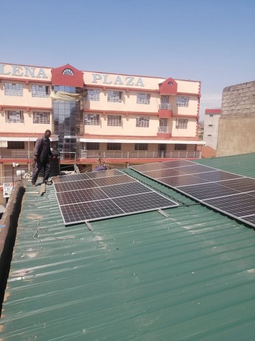 Solar panels being installed on a commercial rooftop in town