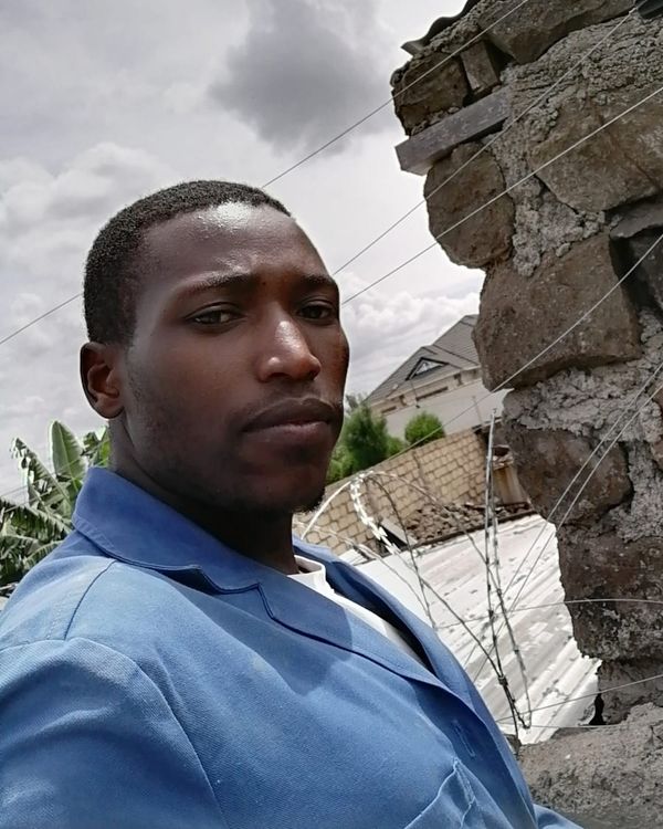 Vegaz technician beside an electric fence on a perimeter wall