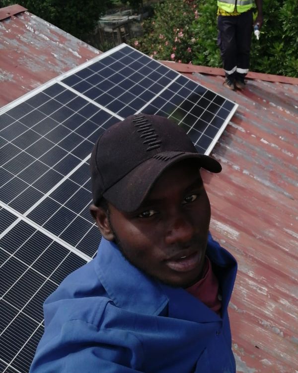 Vegaz technician on a roof beside newly installed solar panels