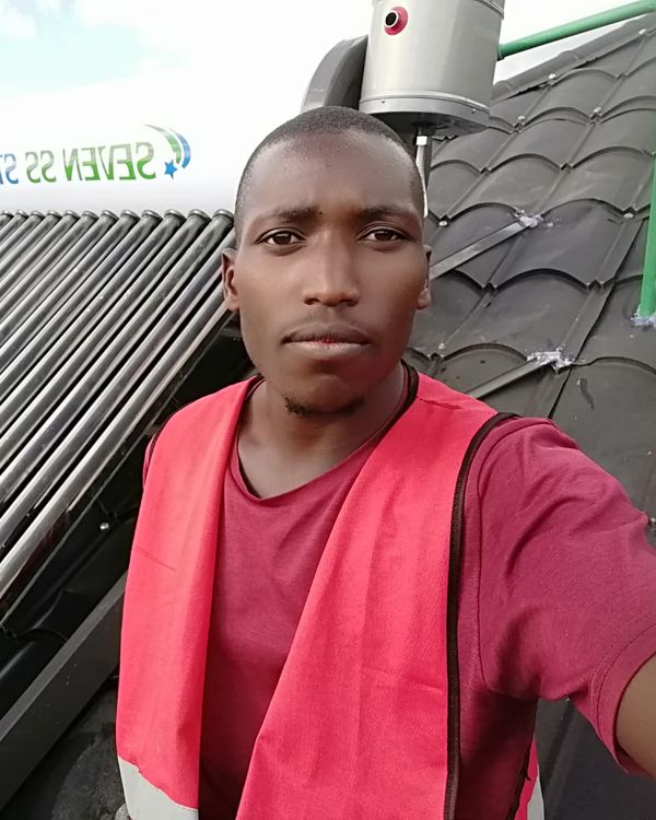 Vegaz technician next to a solar water heater